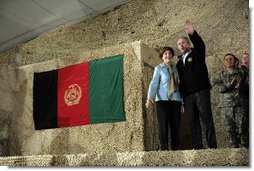 President George W. Bush and Laura Bush wave to an audience of U.S. and Coalition troops, Wednesday, March 1, 2006, upon their arrival to Bagram Air Base in Afghanistan. White House photo by Eric Draper