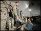 Mrs. Laura Bush greets U.S. and Coalition troops Wednesday, March 1, 2006, during a stopover at Bagram Air Base in Afghanistan, prior to the President and Mrs. Bush visiting India and Pakistan. White House photo by Eric Draper