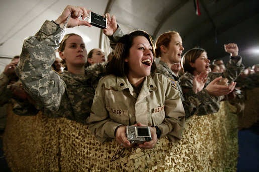 U.S. and Coalition troops cheer and take photos Wednesday, March 1, 2006, during an appearance by President George W. Bush and Mrs. Laura Bush at Bagram Air Base in Afghanistan. White House photo by Eric Draper