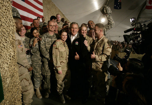 President George W. Bush poses for photos with U.S. and Coalition troops Wednesday, March 1, 2006, during a stopover at Bagram Air Base in Afghanistan, prior to his visit to India and Pakistan. White House photo by Eric Draper