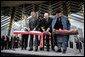 President George W. Bush and Afghanistan President Hamid Karzai, right, cut the ceremonial ribbon, Wednesday, March 1, 2006, to dedicate the new U.S. Embassy Building in Kabul, Afghanistan. President Bush is joined by Mrs. Laura Bush; U.S. Secretary of State Condoleezza Rice and U.S. Ambassador to Afghanistan Ronald E. Neumann. White House photo by Eric Draper