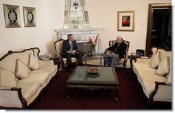 President George W. Bush and Afghan President Hamid Karzai talk Wednesday, March 1, 2006, in the Presidential Palace in Kabul. President and Mrs. Bush made the surprise five-hour stop in Afghanistan en route to India.  White House photo by Eric Draper