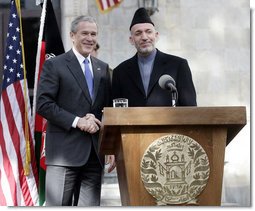 President George W. Bush and President Hamid Karzai of Afghanistan appear together Wednesday, March 1, 2006 at a joint news conference at the Presidential Palace in Kabul, Afganistan.  White House photo by Eric Draper