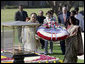 President George W. Bush and Laura Bush participate in a wreath-laying ceremony Thursday, March 2, 2006, in Rajghat, India, at the memorial for Mahatma Gandhi. White House photo by Eric Draper