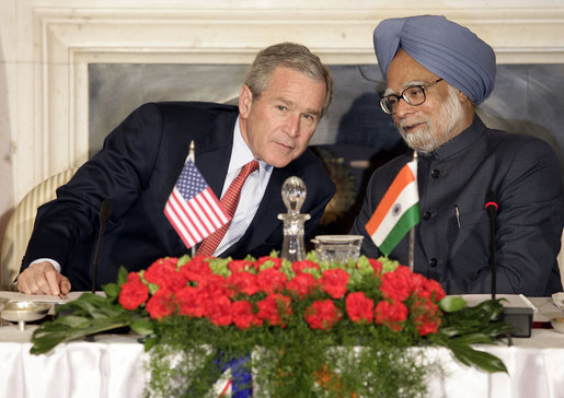 President George W. Bush leans in to speak with India's Prime Minister Manmohan Singh during meetings Thursday, March 2, 2006, in New Delhi. White House photo by Eric Draper