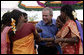 President George W. Bush is surrounded by fans as they pose for photos Friday, March 3, 2006, at the Acharya N.G. Ranga Agriculture University in Hyderabad, India. White House photo by Eric Draper