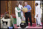 President George W. Bush has fun with some of the produce grown at the Acharya N.G. Ranga Agriculture University as he spends time there Friday, March 3, 2006, in Hyderabad, India. White House photo by Eric Draper