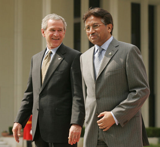 President George W. Bush and Pakistan President Pervez Musharraf walk together to their joint news conference at Aiwan-e-Sadr in Islamabad, Pakistan, Saturday, March 4, 2006. White House photo by Shealah Craighead