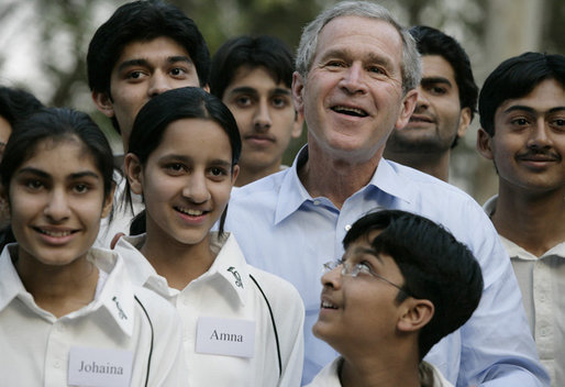 President George W. Bush poses with Pakistani youth from the Schola Nova school and the Islamabad College for Boys, Saturday, March 4, 2006, at the Raphel Memorial Gardens on the grounds of the U.S. Embassy in Islamabad, Pakistan, following his participation in a cricket clinic. White House photo by Eric Draper