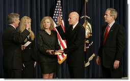 President George W. Bush joins Victoria Lazear and her daughter Julie as Chief of Staff Andy Card swears in Eddie Lazear Monday, March 6, 2006, as Chairman of the Council of Economic Advisers during a ceremony in the Eisenhower Executive Office Building.  White House photo by Kimberlee Hewitt