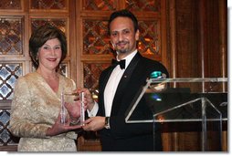 Mrs. Laura Bush is presented with an award by Kuwait Ambassador Al-Sabah, Tuesday evening, March 8, 2006 at the at "Bridges of Hope: Educating Children for a Better Future," The Kuwait-America Foundation's 2006 Benefit Dinner in Washington, in honor of her dedication to help improve the living conditions and education of children around the world.  White House photo by Shealah Craighead