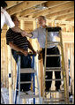 President George W. Bush shakes hands with people helping rebuild Jerry Akins family home, Wednesday, March 8, 2006 in Gautier, Miss., on the site where the Akins home was destroyed by Hurricane Katrina. White House photo by Eric Draper