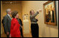 Mrs. Laura Bush listens Thursday evening, March 9, 2006 to Jane Milosch, curator of the Smithsonian American Art Museum's Renwick Gallery in Washington, as Mrs. Bush is shown the famous Grant Wood painting "American Gothic," during a tour of the Renwick Gallery exhibit, "Grant Wood's Studio: Birthplace of American Gothic," scheduled to open Friday, March 10, 2006. Mrs. Bush is accompanied on the tour by Ned. L. Rifkin, under secretary of art at the Smithsonian Institution. White House photo by Shealah Craighead