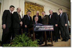 President George W. Bush is joined by House and Senate representatives as he signs H.R. 3199, USA Patriot Improvement and Reauthorization Act of 2005, Thursday, March 9, 2006 in the East Room of the White House. From left to right are U.S. Sen. Jim Talent, R-Mo.; U.S. Sen. Pat Roberts, R-Kan.; U.S. Rep. Peter King, R-NY; U.S. Rep. Jim Sensenbrenner, R-Wis.; U.S. Sen. Arlen Specter, R-Pa.; House Speaker Dennis Hastert, R-Ill., and Majority Whip U.S. Rep. Roy Blunt, R- Mo. White House photo by Eric Draper