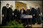 President George W. Bush is joined by House and Senate representatives as he signs H.R. 3199, USA Patriot Improvement and Reauthorization Act of 2005, Thursday, March 9, 2006 in the East Room of the White House. From left to right are U.S. Sen. Jim Talent, R-Mo.; U.S. Sen. Pat Roberts, R-Kan.; U.S. Rep. Peter King, R-NY; U.S. Rep. Jim Sensenbrenner, R-Wis.; U.S. Sen. Arlen Specter, R-Pa.; House Speaker Dennis Hastert, R-Ill., and Majority Whip U.S. Rep. Roy Blunt, R- Mo. White House photo by Eric Draper