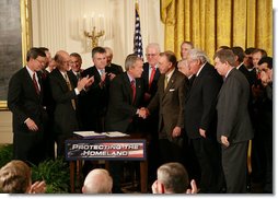 President George W. Bush shakes hands with U.S. Senator Arlen Specter, R. Pa., after signing H.R. 3199, USA PATRIOT Improvement and Reauthorization Act of 2005, Thursday, March 9, 2006 in the East Room of the White House. White House photo by Kimberlee Hewitt