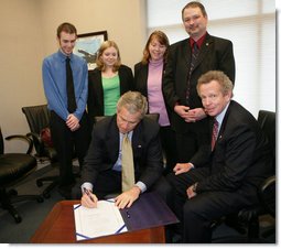 President George W. Bush is joined Tuesday, March 14, 2006 at the Rochester, N.Y., International Airport by family members of Marine Corporal Jason L. Dunham, who was killed in action in the Al Anbar Province of Iraq in April 2004, as President Bush signs a bill designating the post office of Scio, N.Y., to be named the Cpl. Jason L. Dunham Post Office. From left to right are Jason's brother, Kyle James Dunham; sister, Katie; parents, Dan and Deb Dunham, and U.S. Rep. John R. "Randy" Kuhl, Jr., R-N.Y. White House photo by Kimberlee Hewitt