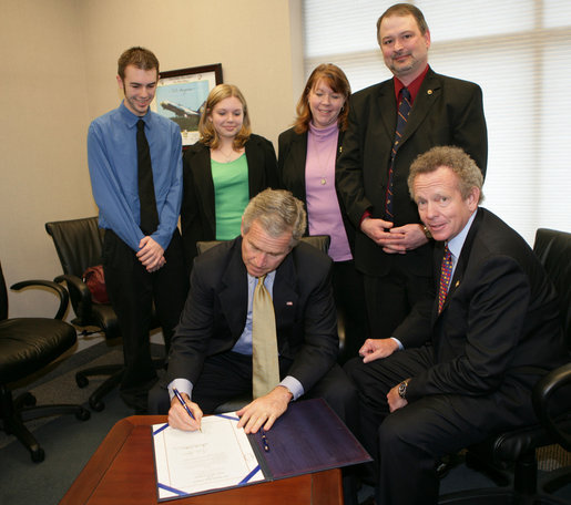 President George W. Bush is joined Tuesday, March 14, 2006 at the Rochester, N.Y., International Airport by family members of Marine Corporal Jason L. Dunham, who was killed in action in the Al Anbar Province of Iraq in April 2004, as President Bush signs a bill designating the post office of Scio, N.Y., to be named the Cpl. Jason L. Dunham Post Office. From left to right are Jason's brother, Kyle James Dunham; sister, Katie; parents, Dan and Deb Dunham, and U.S. Rep. John R. "Randy" Kuhl, Jr., R-N.Y. White House photo by Kimberlee Hewitt