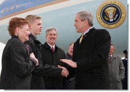 President George W. Bush greets Greece Athena High School senior, Jason McElwain and McElwain's mother, Debbie, upon arriving in Rochester, New York Tuesday, March 14, 2006. After serving as the team's manager McElwain, who is autistic, was called on to play during the team's last game of the season. McElwain became a local hero after he sank six 3-point shots during the last moments of his first ever varsity basketball game. White House photo by Kimberlee Hewitt