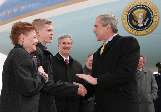 President George W. Bush greets Greece Athena High School senior, Jason McElwain and McElwain's mother, Debbie, upon arriving in Rochester, New York Tuesday, March 14, 2006. After serving as the team's manager McElwain, who is autistic, was called on to play during the team's last game of the season. McElwain became a local hero after he sank six 3-point shots during the last moments of his first ever varsity basketball game. White House photo by Kimberlee Hewitt