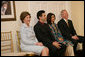 Mrs. Laura Bush attends the Afghan Children's Initiative Benefit Dinner at the Afghanistan Embassy in Washington, DC on Thursday evening, March 16, 2006. Seated with Mrs. Bush are Dr. Khaled Hosseini, author of The Kite Runner; Mrs. Shamim Jawad, host and wife of the Afghan Ambassador to the U.S.; and Mr. Tim McBride, member of the U.S.-Afghan Women's Council. White House photo by Shealah Craighead