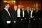 President George W. Bush is joined by House Speaker Dennis Hastert (R-Ill.), right, and Prime Minister Bertie Ahern of Ireland, as they stand with the McCrohan Tenors after the trio's performance Thursday, March 16, 2006, during a St. Patrick's Day Luncheon at the U.S. Capitol. White House photo by Kimberlee Hewitt