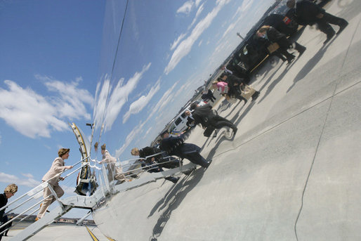 Mrs. Laura Bush and members of her staff are reflected along the side of her aircraft, Thursday, March 16, 2006 , as they depart Newark LIberty International Airport en route to Andrews AFB. Mrs. Bush visited the Avon Ave Elementary School in Newark to announce a Striving Readers grant to Newark Public Schools, to support programs to improve students reading skills. White House photo by Shealah Craighead