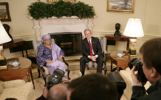 President George W. Bush and Liberia's President Ellen Johnson Sirleaf speak to reporters in the Oval Office at the White House, Tuesday, March 21, 2006. President Sirleaf, the first woman elected President to any country on the continent of Africa, thanked President Bush, the American people and the U.S. Congress for helping support Liberia's transition from war to peace. White House photo by Eric Draper