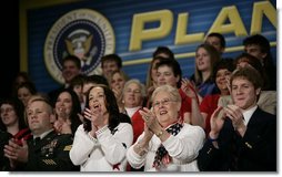 Audience members applaud President George W. Bush as he discusses the global war on terror, Wednesday, March 22, 2006 at the Capitol Music Hall in Wheeling, W. Va. President Bush told the crowd that America has got to appreciate what it means to wear the uniform today, and honor those who have volunteered to keep this country strong.  White House photo by Eric Draper