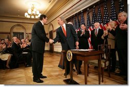 President George W. Bush shakes hands with Ukrainian Ambassador Oleh Shamshur, after President Bush signed H.R. 1053, to authorize the Extension of Nondiscriminatory Treatment to the Products of Ukraine, Thursday, March 23, 2006, in the Eisenhower Executive Office Building in Washington. President Bush was joined at the ceremony by legislators, U.S. Sen. Richard Lugar, R- Ind.; U.S. Rep. Jim Gerlach, R-Pa.; U.S. Rep. Tom Lantos, D-Calif.; U.S. Rep. Candice Miller, R-Mich; U.S. Rep. Curt Weldon, R-Pa., and U.S. Rep. Mike Fitzpatrick, R-Pa.  White House photo by Kimberlee Hewitt