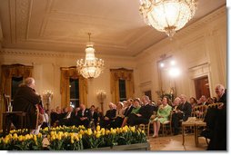 President George W. Bush and Mrs. Laura Bush join their invited guests in listening to Benjamin Franklin interpreter, Ralph Archbold of Philadelphia, Pa., Thursday evening, March 23, 2006 in the East Room of the White House, during a Social Dinner to honor the 300th birthday of Benjamin Franklin.  White House photo by Shealah Craighead