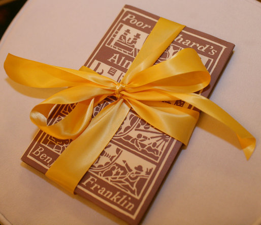 A decorated copy of Benjamin Franklin's Poor Richard's Almanack awaits guests Thursday evening, March 23, 2006 in the Blue Room of the White House, at a Social Dinner hosted by President George W. Bush and Mrs. Laura Bush in honor of the 300th birthday of Benjamin Franklin. White House photo by Shealah Craighead