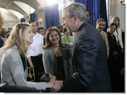 President George W. Bush congratulates newly sworn-in U.S. citizens Monday, March 27, 2006, following the Naturalization Ceremony at the Daughters of the American Revolution Administration Building in Washington. President Bush told the new U.S. citizens that each generation of immigrants brings a renewal to our national character and adds vitality to our culture.  White House photo by Eric Draper