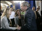 President George W. Bush congratulates newly sworn-in U.S. citizens Monday, March 27, 2006, following the Naturalization Ceremony at the Daughters of the American Revolution Administration Building in Washington. President Bush told the new U.S. citizens that each generation of immigrants brings a renewal to our national character and adds vitality to our culture. White House photo by Eric Draper