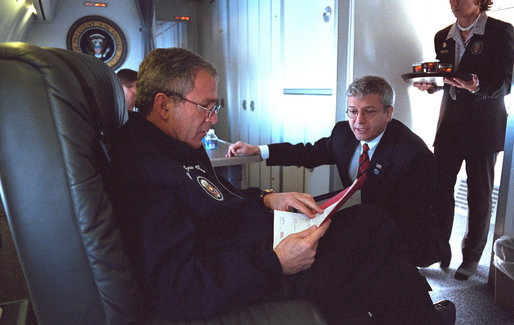 In this January 2002 file photo, President George W. Bush confers with Josh Bolten aboard Air Force One en route to Portland, Maine. President Bush announced Tuesday, March 28, 2006, that Director Bolten, of the Office of Management and Budget, will succeed Secretary Andrew Card as Chief of Staff. White House photo by Eric Draper