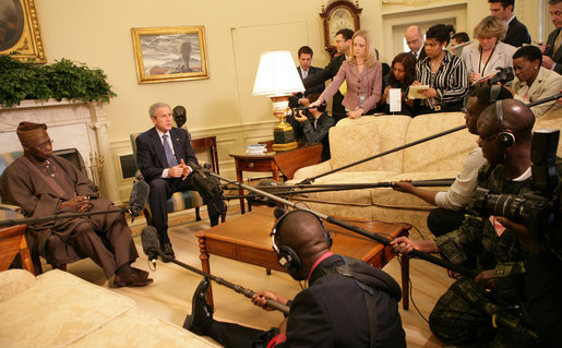 President George W. Bush speaks to the press as they gather Wednesday, March 29, 2006, in the Oval Office for a photo availability with President Olusegun Obasanjo of Nigeria. President Bush thanked President Obasanjo for his leadership and said, "Every time I meet with the President he brings a fresh perspective about the politics and the situation on the continent of Africa." White House photo by Shealah Craighead