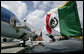 President George W. Bush waves as he prepares to leave Cancun International Airport en route to Texas, Friday, March 31, 2006, following his series of summit meetings with Mexico's President Vicente Fox and Canadian Prime Minister Stephen Harper in Cancun, Mexico, where the three leaders talked about the issues of trade, border security and immigration. White House photo by Eric Draper