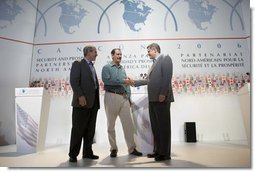 President George W. Bush, Mexico's President Vicente Fox, center, and Canadian Prime Minister Stephen Harper, right, meet to shake hands following their joint news conference, Friday, March 31, 2006 in Cancun, Mexico, at the conclusion of their summit meeting. White House photo by Eric Draper