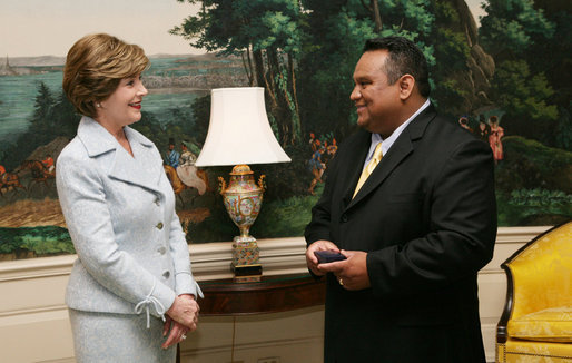 Mrs. Laura Bush enjoys a moment with Sal Tinajero Thursday, April 6, 2006, recipient of Hispanic Magazine's Teacher of the Year award in the Diplomatic Room at the White House. Along with being a World History teacher, Mr. Tinajero resurrected the Speech and Debate team at Fullerton Union High School in Santa Ana, California. White House photo by Shealah Craighead