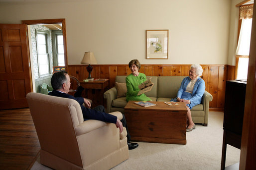 Mrs. Laura Bush, Mrs. Barbara Bush, and former President George H.W. Bush share a moment in the living room of President George W. Bush’s Childhood Home in Midland, Texas, on Tuesday, April 11, 2006, prior to a dedication and ribbon cutting ceremony of the home. White House photo by Shealah Craighead