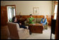 Mrs. Laura Bush, Mrs. Barbara Bush, and former President George H.W. Bush share a moment in the living room of President George W. Bush’s Childhood Home in Midland, Texas, on Tuesday, April 11, 2006, prior to a dedication and ribbon cutting ceremony of the home. White House photo by Shealah Craighead