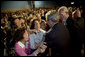 Audience members greet and hug President George W. Bush after his talk about the Medicare prescription drug benefits at the Richard J. Ernst Community Center at Northern Virginia Community College in Annandale, Va., Wednesday, April 12, 2006. President Bush urged senior citizens to participate in the new Medicare program to reduce their drug costs. White House photo by Kimberlee Hewitt