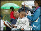 U.S. Secretary of Housing and Urban Development Alphonso Jackson is joined by family friend Willard Jackson Jr., as he reads to a gathering of children at the 2006 White House Easter Egg Roll, Monday, April 17, 2006 on the South Lawn of the White House. White House Photo by Julie Kubal 