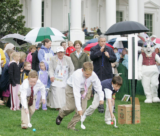 President George W. Bush is joined by Mrs. Laura Bush as he blows a whistle to start an Easter Egg Roll race on the South Lawn of the White House during the annual 2006 White House Easter Egg Roll, Monday, April 17, 2006. The first White House Easter Egg Roll was held in 1878. White House photo by Kimberlee Hewitt