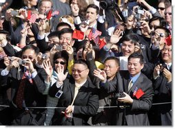 Guests wave enthusiastically as Presidents George W. Bush and Hu Jintao pass by during the South Lawn Arrival Ceremony for the Chinese President, Thursday, April 20, 2006. White House photo by Kimberlee Hewitt