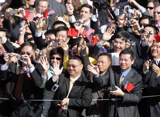 Guests wave enthusiastically as Presidents George W. Bush and Hu Jintao pass by during the South Lawn Arrival Ceremony for the Chinese President, Thursday, April 20, 2006. White House photo by Kimberlee Hewitt