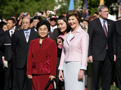 Mrs. Laura Bush stands with Liu Yongqing, the wife of Chinese President Hu Jintao, during the South Lawn Arrival Ceremony, Thursday, April 20, 2006. White House photo by Shealah Craighead