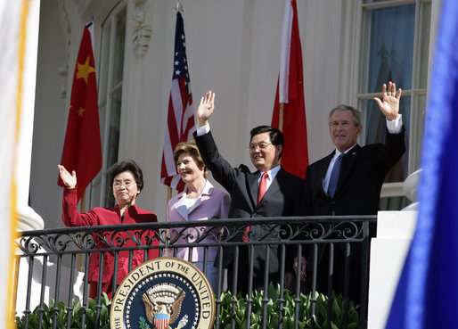 President George W. Bush, Chinese President Hu Jintao, Laura Bush and Hu's wife, Liu Yongqing, wave from the South Portico balcony after the South Lawn Arrival Ceremony at the White House, Thursday, April 20, 2006. White House photo by Shealah Craighead