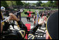 As trumpeters perform, President George W. Bush, President Hu Jintao, Laura Bush, and Hu’s wife, Liu Yongqing, walk into the White House after an arrival ceremony on the South Lawn, Thursday, April 20, 2006. White House photo by David Bohrer