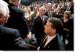 President George W. Bush reaches out to shake the hand of an audience member Monday, April 24, 2006, after addressing the Orange County Business Council in Irvine, Calif.  White House photo by Eric Draper